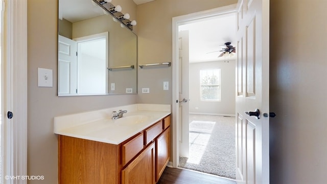 bathroom with ceiling fan, vanity, and hardwood / wood-style floors