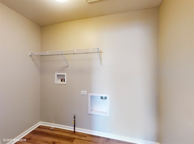 washroom with wood-type flooring and hookup for a washing machine