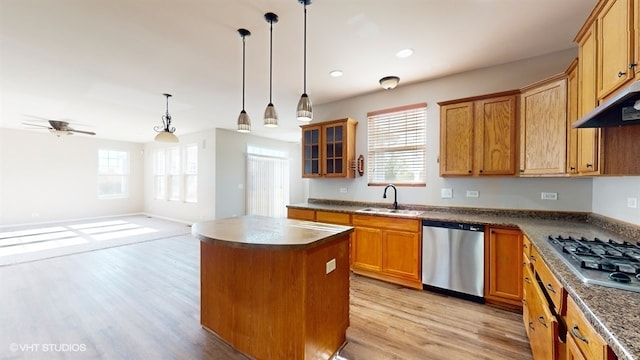 kitchen featuring appliances with stainless steel finishes, sink, a healthy amount of sunlight, and a kitchen island