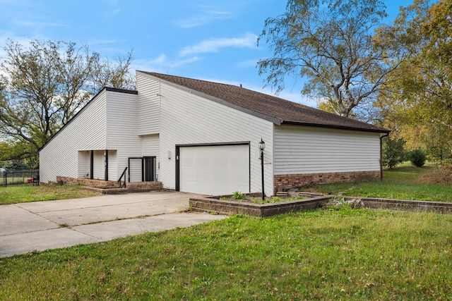 view of side of home featuring a yard and a garage