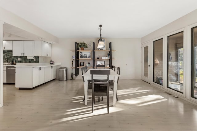 dining area featuring light wood-type flooring