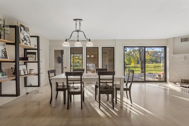 dining space with wood-type flooring