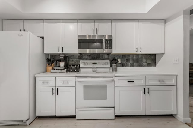 kitchen with decorative backsplash, white cabinets, light hardwood / wood-style floors, and white appliances