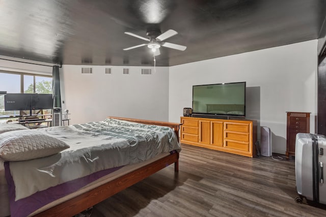 bedroom with dark hardwood / wood-style floors and ceiling fan