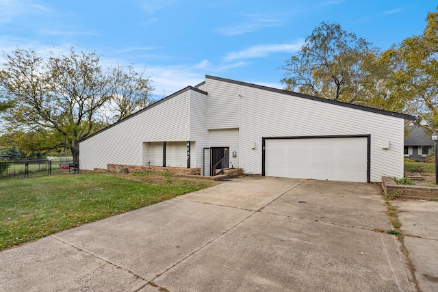 view of side of home featuring a yard and a garage