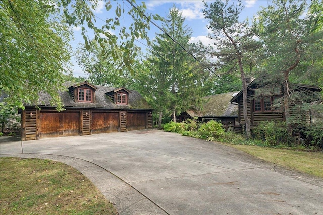 378 Oakland Dr, Highland Park, IL 60035 - view of front of property with concrete driveway and a detached garage