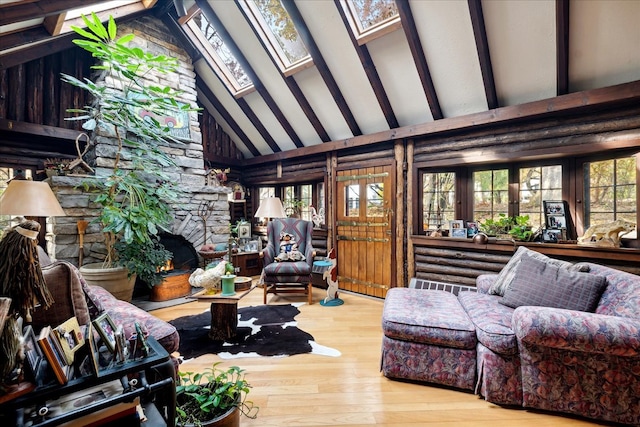 living room with beam ceiling, hardwood / wood-style flooring, high vaulted ceiling, and a skylight