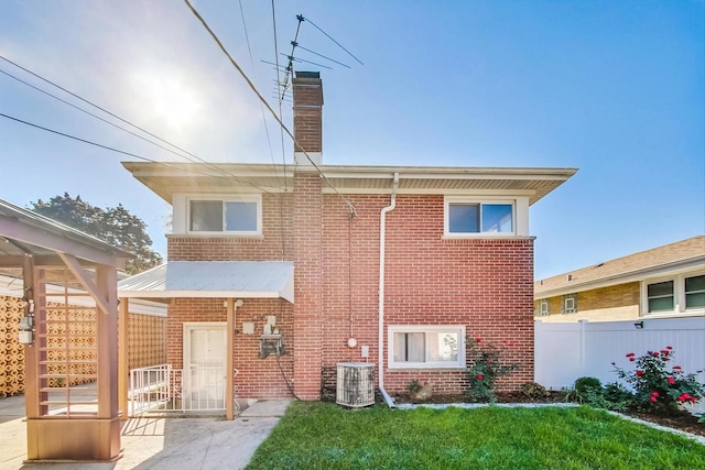 back of house featuring a patio area, central AC, and a lawn