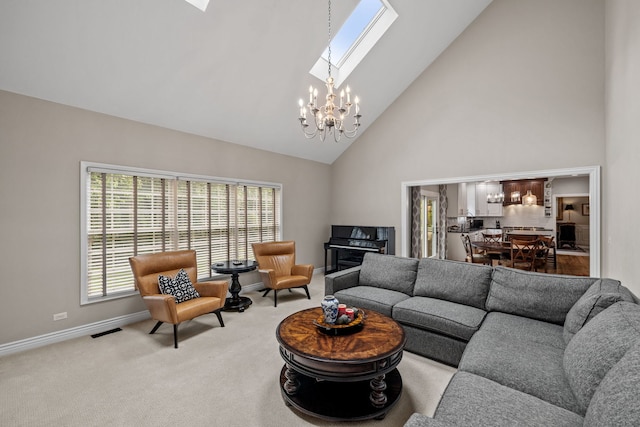 living room featuring an inviting chandelier, carpet floors, high vaulted ceiling, and a skylight