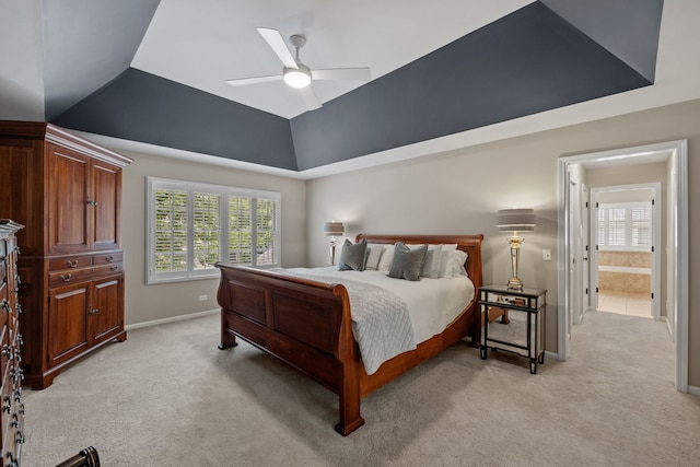 bedroom with ceiling fan, connected bathroom, and light carpet