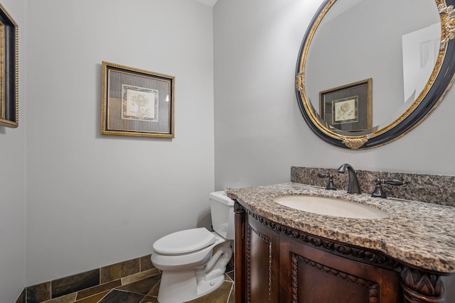 bathroom with vanity, tile patterned flooring, and toilet