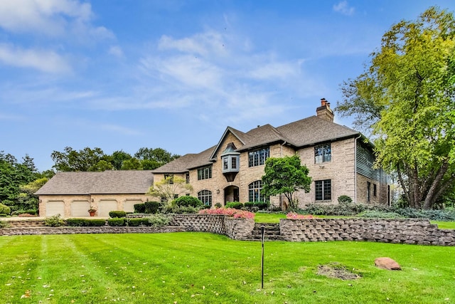 view of front of property featuring a garage and a front yard