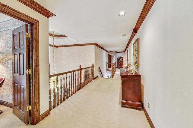 hall with crown molding and light colored carpet