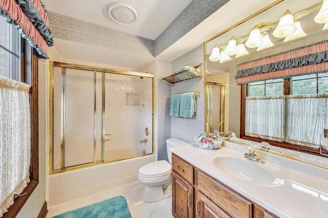 full bathroom with toilet, vanity, shower / bath combination with glass door, and tile patterned flooring