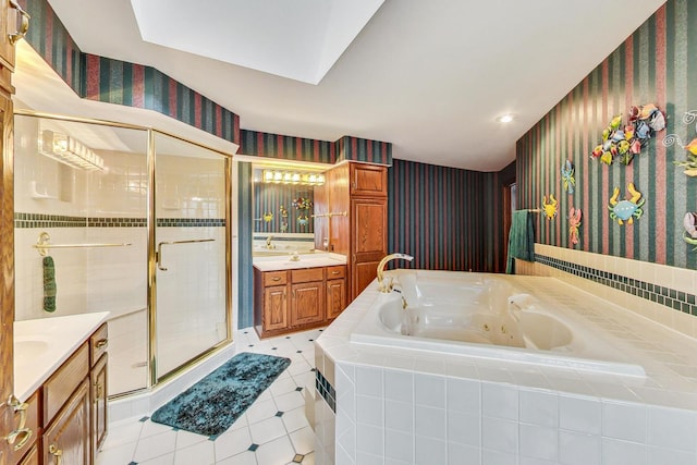 bathroom featuring independent shower and bath, vanity, and tile patterned flooring