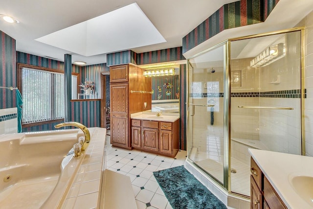 bathroom featuring vanity and shower with separate bathtub