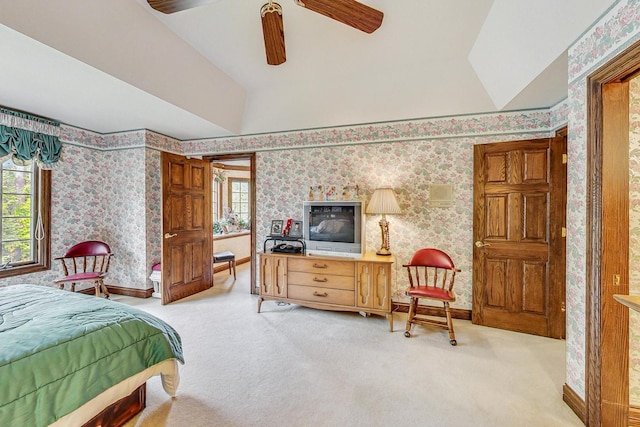 carpeted bedroom with vaulted ceiling and ceiling fan