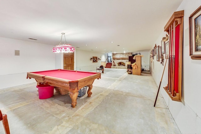 rec room with pool table and a fireplace