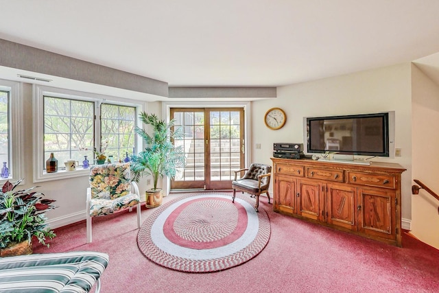 living area featuring light carpet