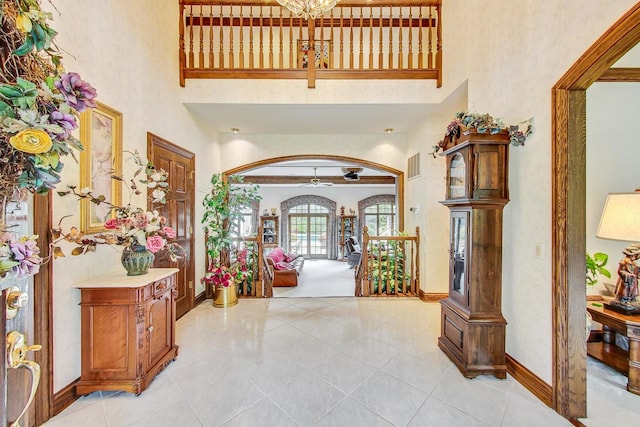 tiled foyer entrance with a high ceiling