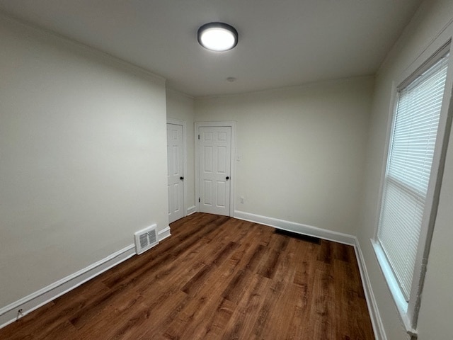 unfurnished room featuring dark wood-type flooring