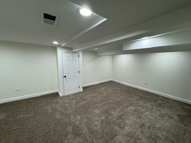 basement featuring dark carpet