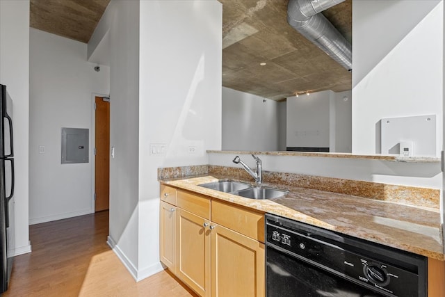 kitchen featuring light stone counters, black appliances, sink, light hardwood / wood-style flooring, and electric panel