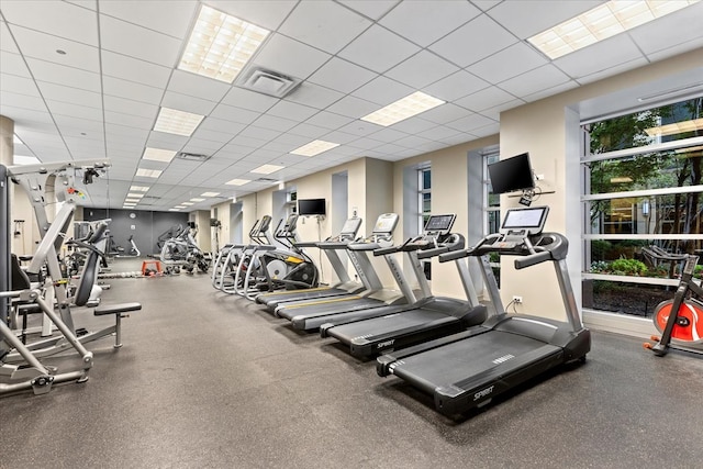 gym with a paneled ceiling