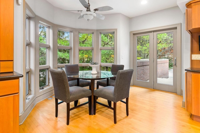 dining space with light wood-type flooring, a wealth of natural light, and ceiling fan