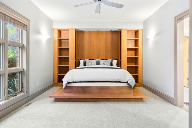 bedroom featuring light colored carpet and ceiling fan