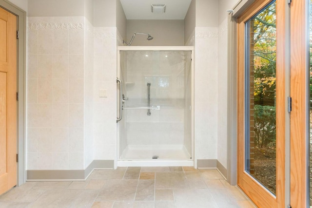 bathroom with a shower with shower door