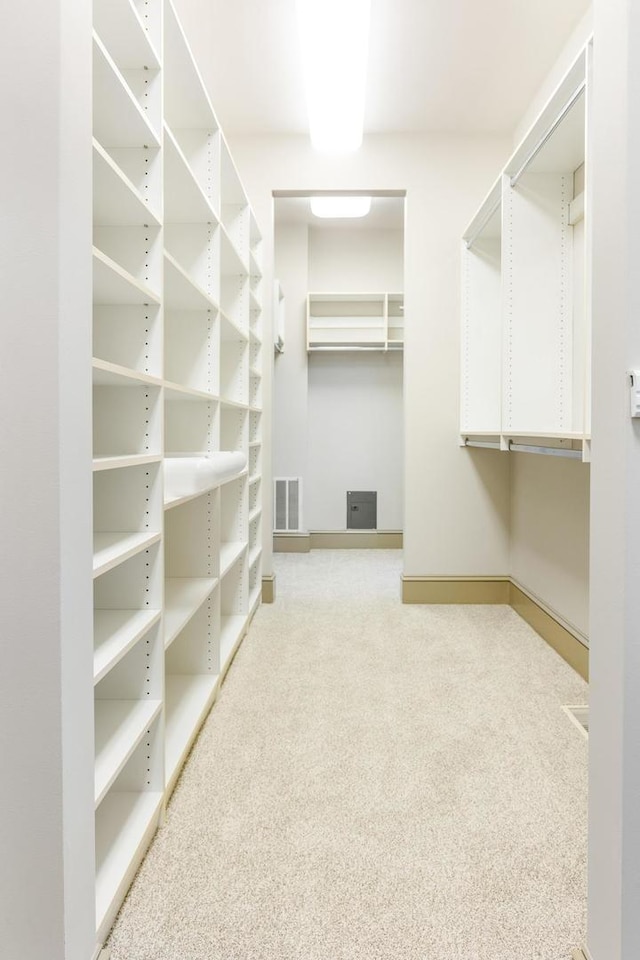 walk in closet featuring carpet and an AC wall unit