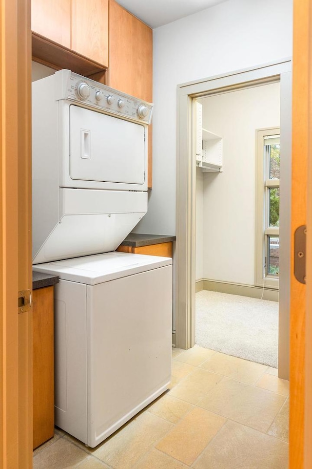 laundry room featuring stacked washer and clothes dryer