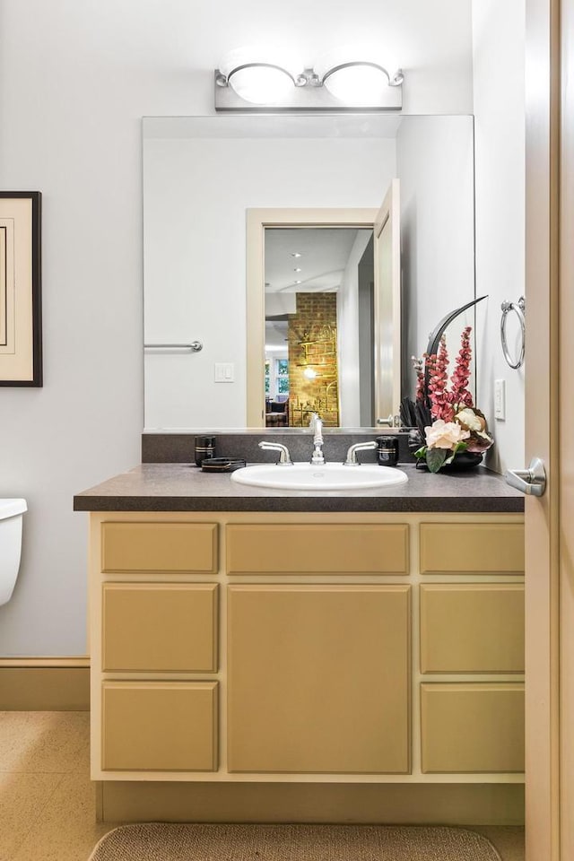 bathroom featuring vanity and toilet