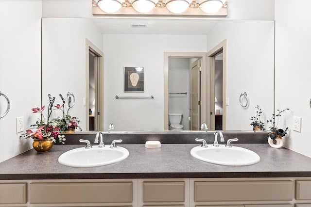 bathroom featuring vanity and toilet