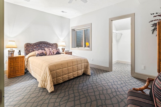 bedroom featuring carpet flooring, ceiling fan, and a walk in closet