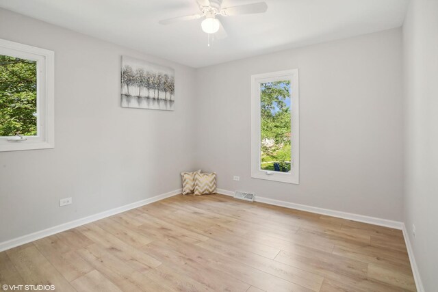 unfurnished living room with an inviting chandelier and light hardwood / wood-style flooring