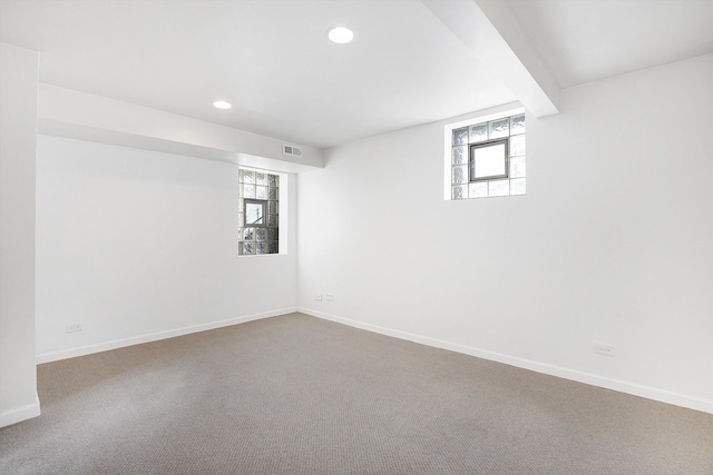 basement with carpet flooring and a healthy amount of sunlight