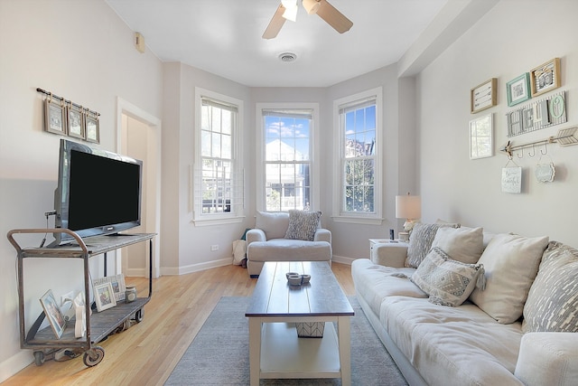 living room with ceiling fan and light hardwood / wood-style floors