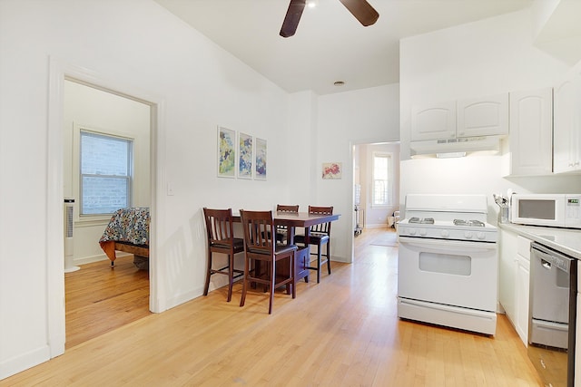 kitchen with ceiling fan, light wood-type flooring, white appliances, and white cabinetry