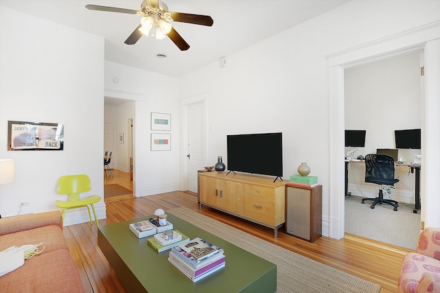 living room featuring ceiling fan and hardwood / wood-style flooring