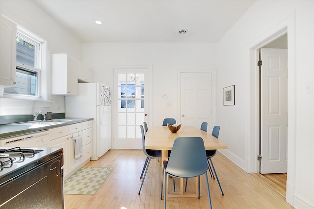 dining room featuring sink and light hardwood / wood-style floors