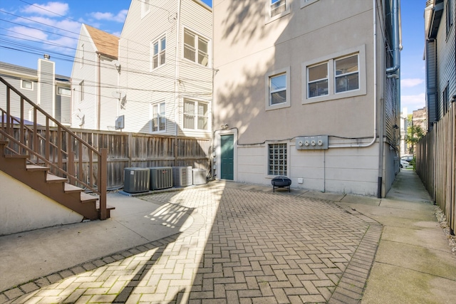 back of house featuring central AC and a patio area