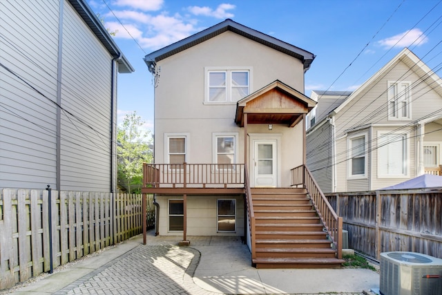 back of house with a deck, cooling unit, and a patio area