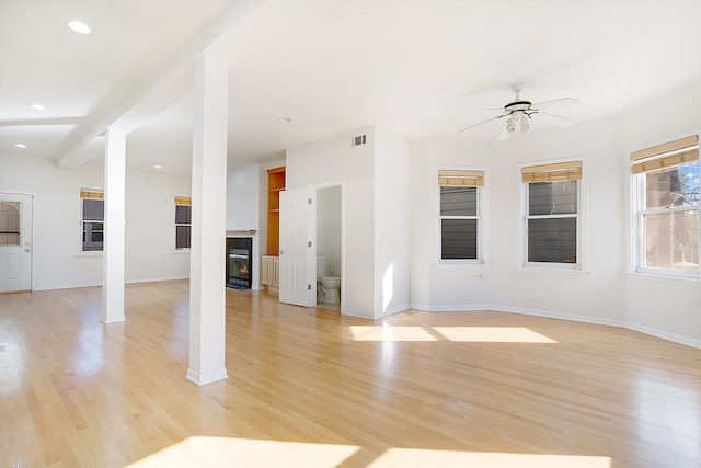 unfurnished living room with light wood-type flooring and ceiling fan