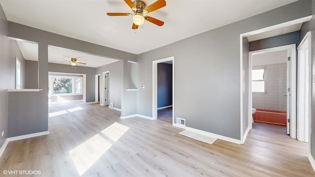 unfurnished living room featuring light wood-type flooring and ceiling fan