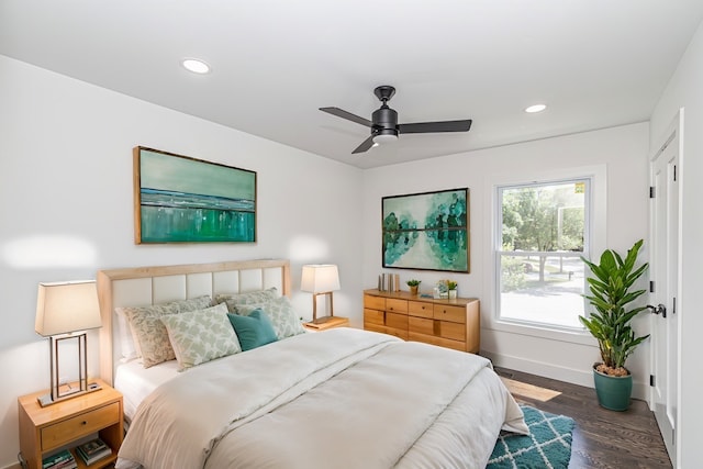 bedroom featuring ceiling fan and dark hardwood / wood-style floors