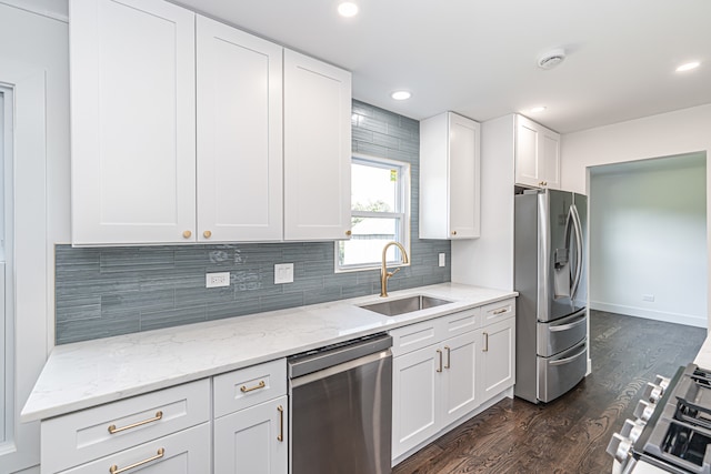 kitchen featuring dark wood-type flooring, appliances with stainless steel finishes, sink, and white cabinets