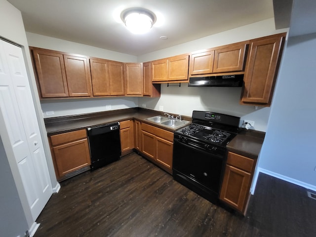 kitchen with black appliances, dark wood-type flooring, and sink