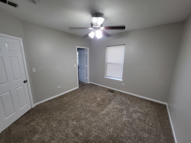 carpeted spare room with ceiling fan